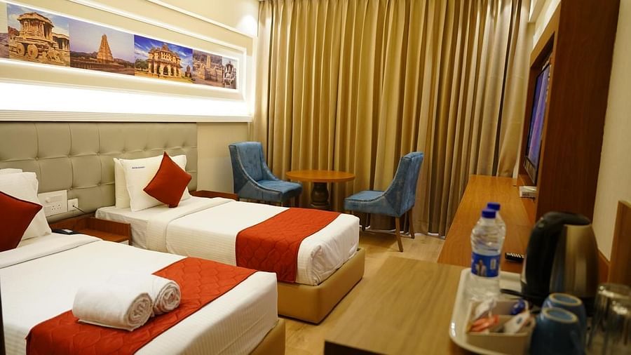 Wide view of the elegant twin room with large window and modern furnishings at Kalyan Residency Hotel, Tirupati.