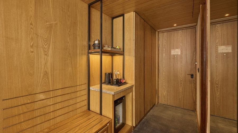 Wood-panelled entryway with wardrobe, mirror, and subtle ambient lighting - Royal Tulip, Chitwan