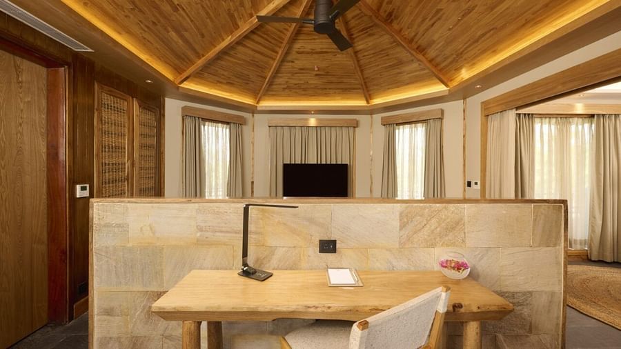A cosy work desk featuring a night lamp and a chair in our villa - Royal Tulip, Chitwan
