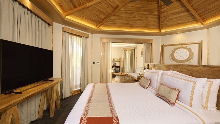 A villa in Chitwan featuring a double bed, of a television, a ceiling fan, and traditional decor - Royal Tulip, Chitwan