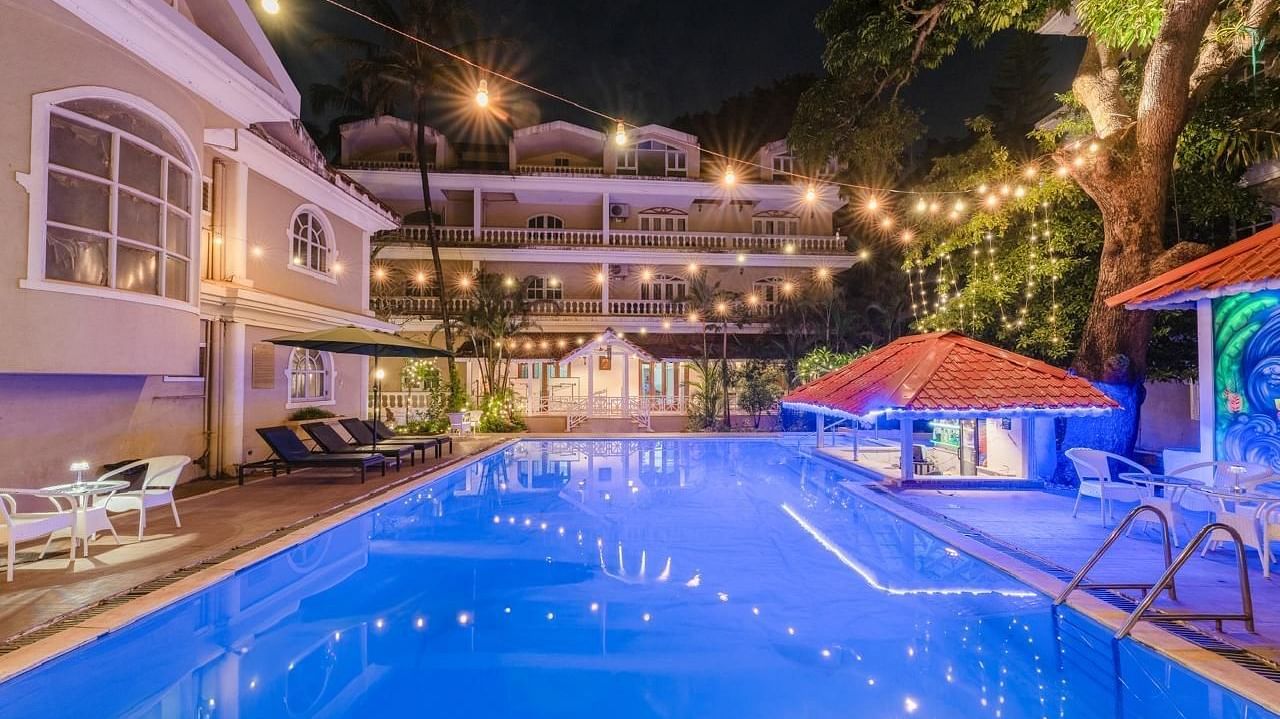 Image of a swimming pool with lights hanging above it at Calux Joia Do Mar Resort, Goa.