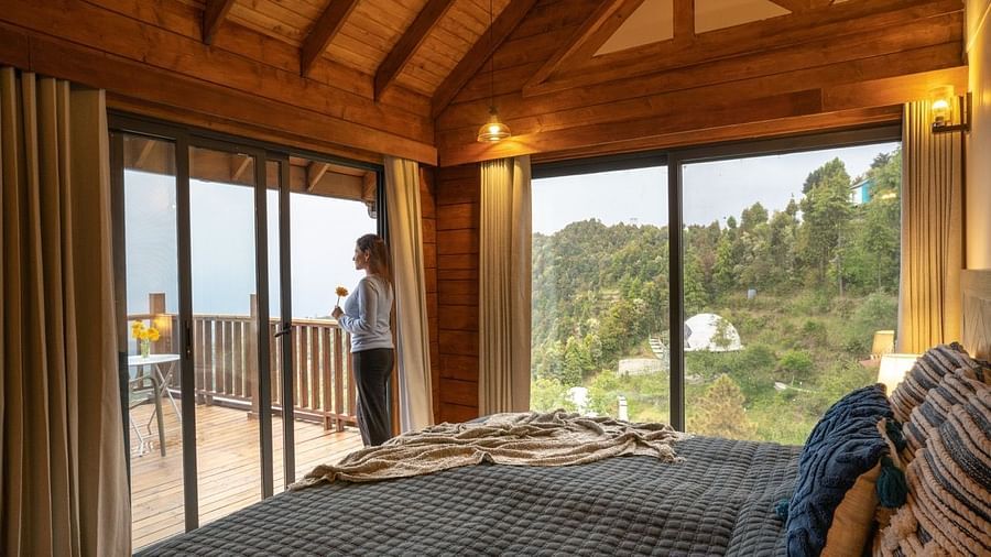 An image of a person staring at the view from a room at avalon cottages