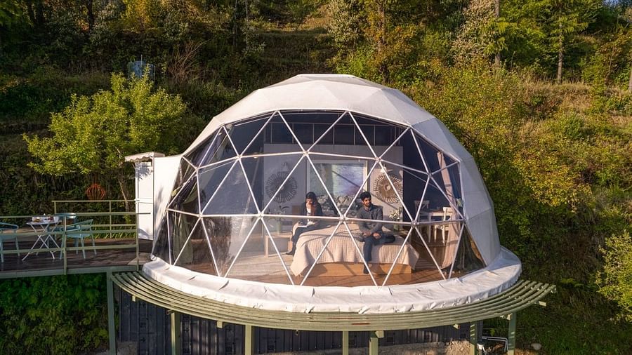 A closer view of a dome cottage with a couple inside | Avalon Cottages, Kanatal