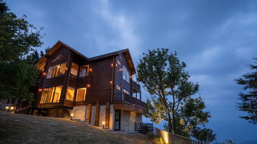 cottage with lights in the evening and blue skies | Avalon Cottages, Kanatal