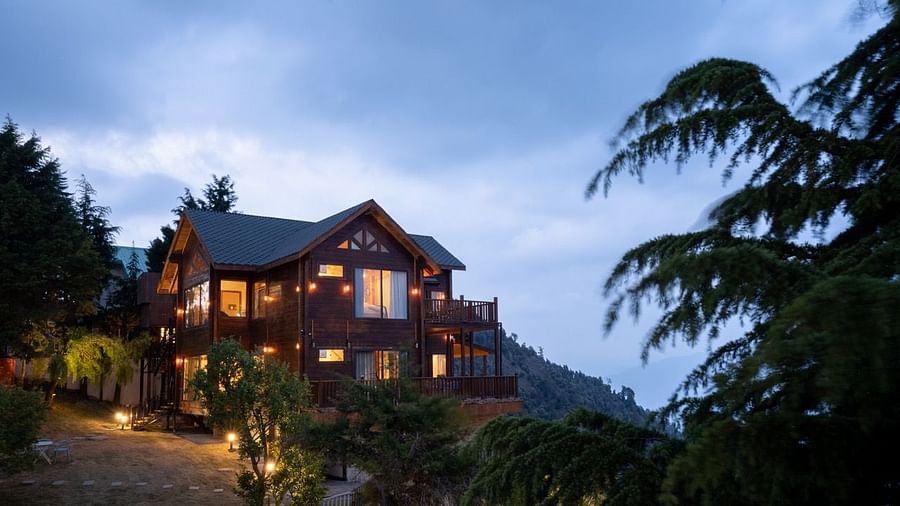 An image of a well lit cottage cottage with trees all around | Avalon Cottages, Kanatal