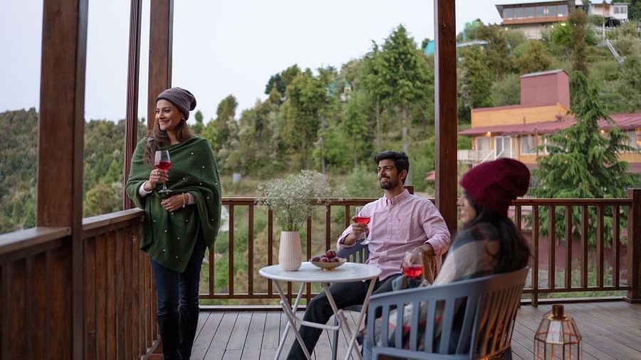 An image of a group of friends enjoying the view and wine | Avalon Cottages, Kanatal