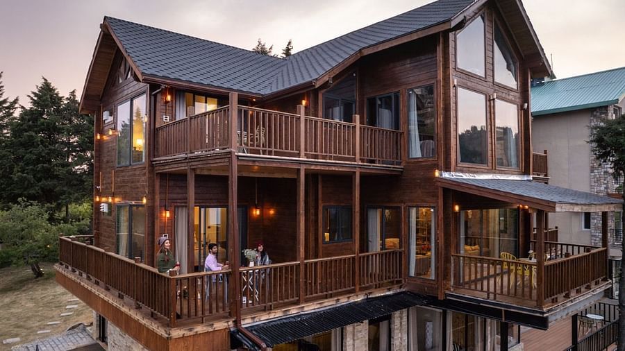An image of a well lit cottage cottage with trees all around | Avalon Cottages, Kanatal