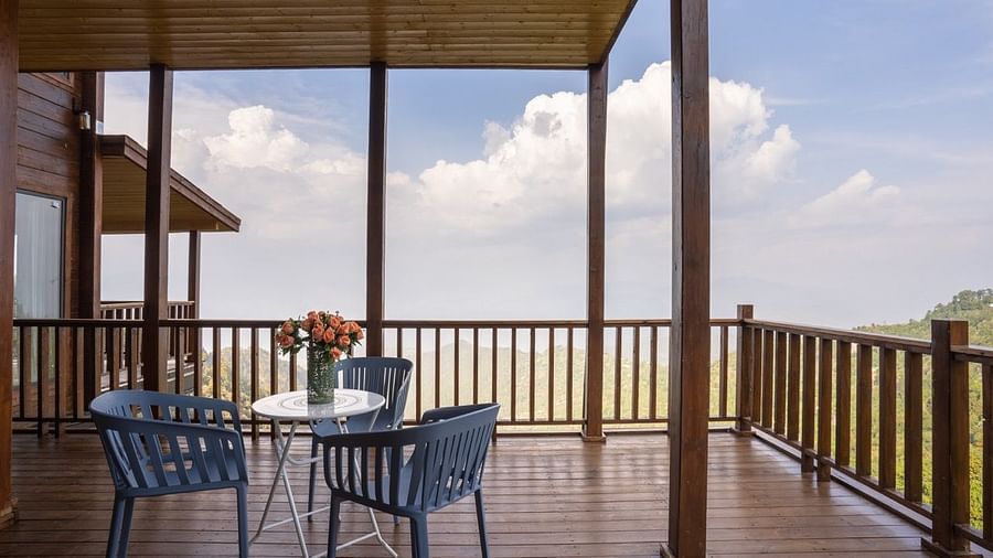 An image of a patio with a view along with seating and wooden flooring