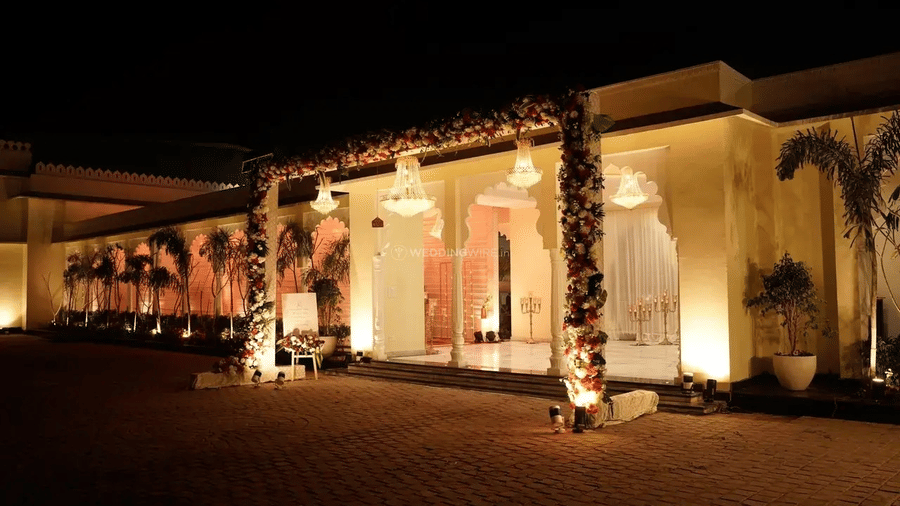Building exterior illuminated with lights during evening at Beelwa Palace, Jaipur