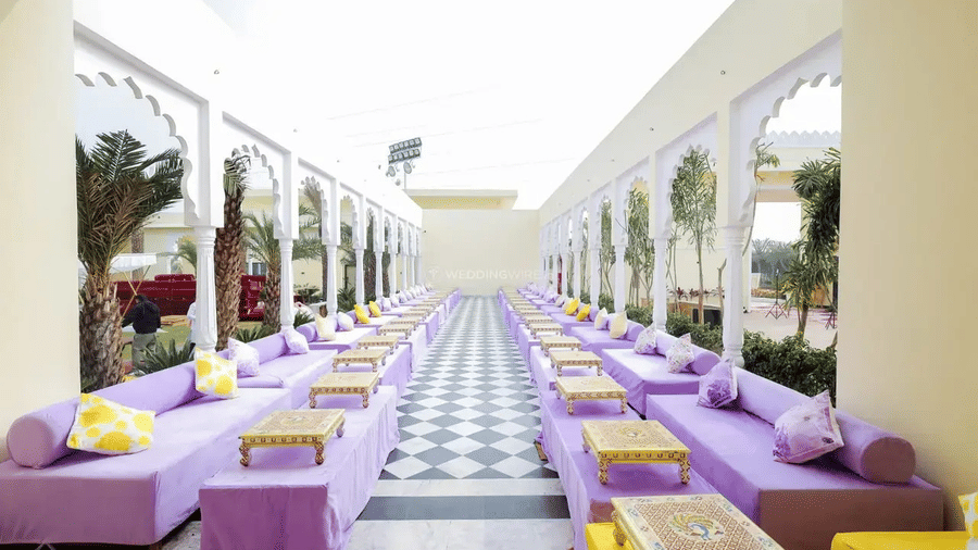 Long corridor with parallel seating setup and cushions along both sides at Beelwa Palace, Jaipur