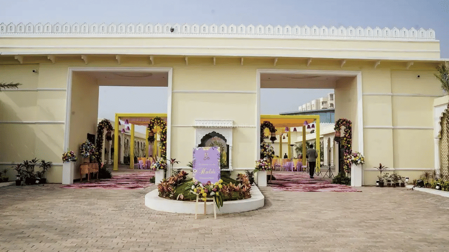 The entrance of a building with two doors and potted plants outside at Beelwa Palace, Jaipur.