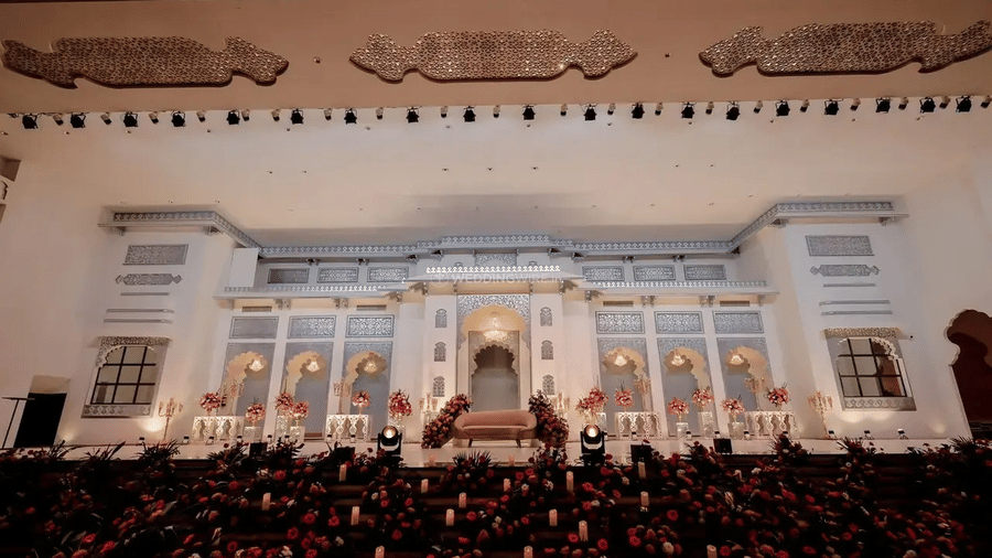 A facade view of Beelwa Palace, Jaipur, showing an illuminated building and sofa arranged for an outdoor event.
