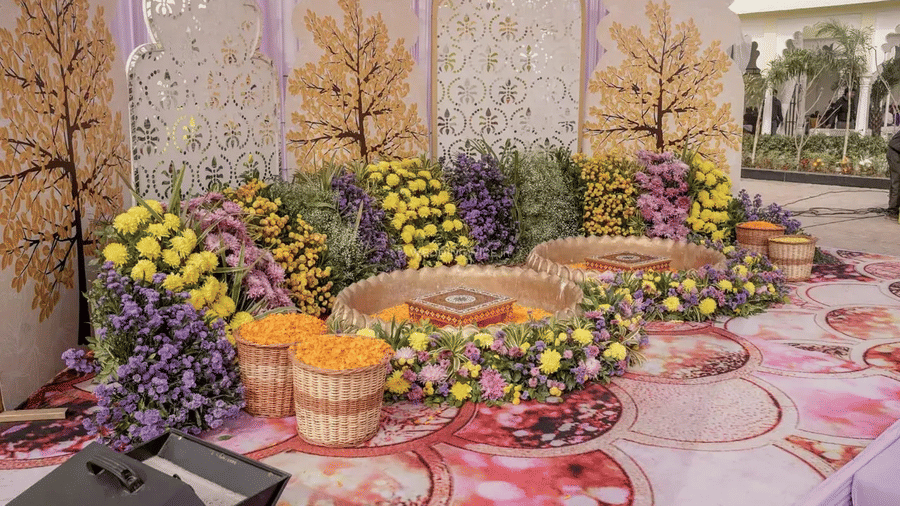 An outdoor floral setup with circular arrangements and decorative backdrop at Beelwa Palace, Jaipur.