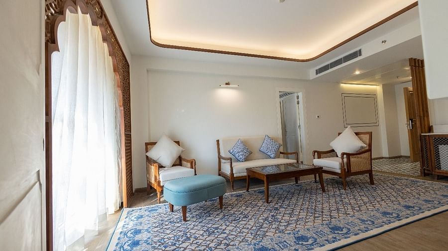 Natural light coming from the arched balcony covered with white linen curtains in the living area of the Ananta at Bhagirathi by RDB Atishay.