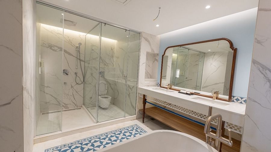 Full view shot of the luxurious bathroom with a fully stocked vanity area and a bathtub at Bhagirathi by RDB Atishay.