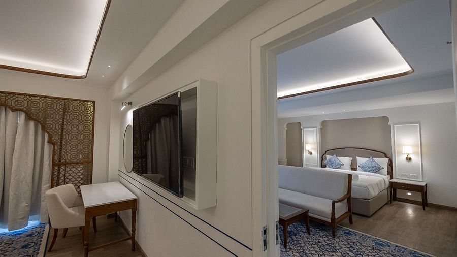 The Ananta Room showcasing a wall mounted television along with a doorway leading to the bedroom at Bhagirathi by RDB Atishay.