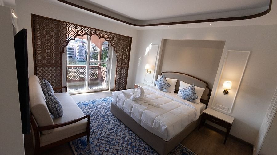 Top view shot of the Jalrupa Room featuring a double bed and a small balcony with huge french windows at Bhagirathi by RDB Atishay.