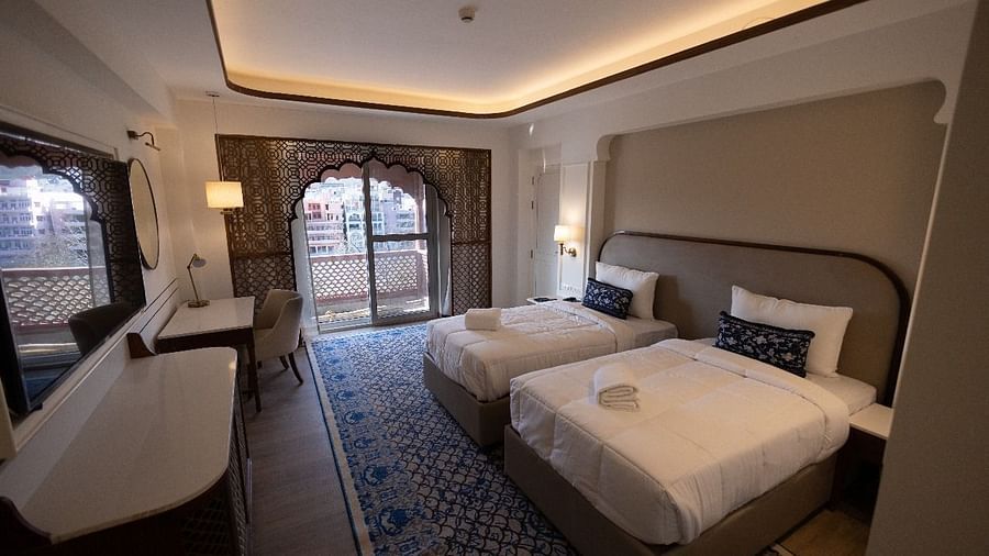 Full view shot of the Jalrupa Room with two comfortable single beds with a false ceiling at Bhagirathi by RDB Atishay.