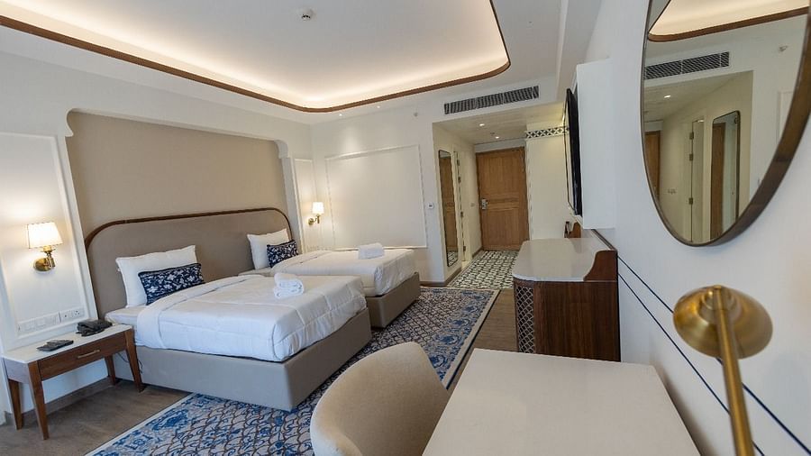 Corner view shot of the Jalrupa room with two single beds along with a work station in the foreground at Bhagirathi by RDB Atishay.