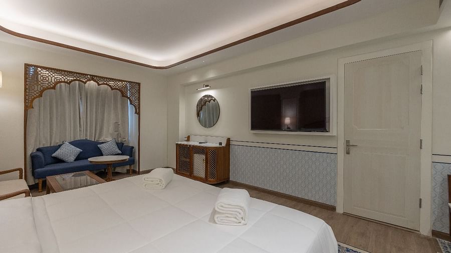 Corner view shot of the Jalrupa room featuring a double bed facing a wall mounted television at Bhagirathi by RDB Atishay.