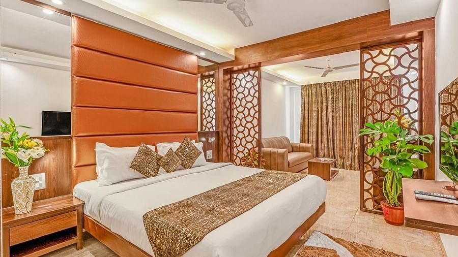 Image of a room with bed, television and plants at Calux Joia Do Mar Resort, Goa.