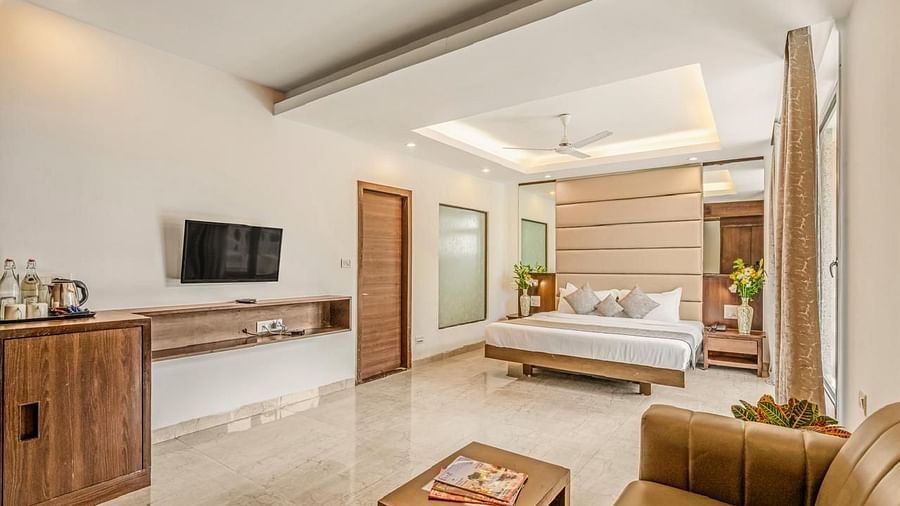 Image of the sitting area at Grand Room with sofa and a television in front at Calux Joia Do Mar Resort, Goa.