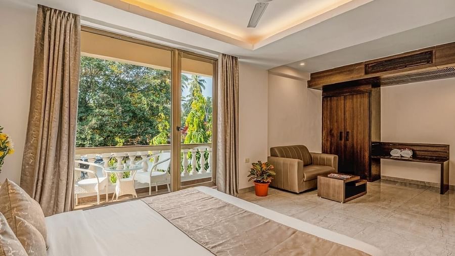 Image of Grand Room with a bed and balcony on the side at Calux Joia Do Mar Resort, Goa.