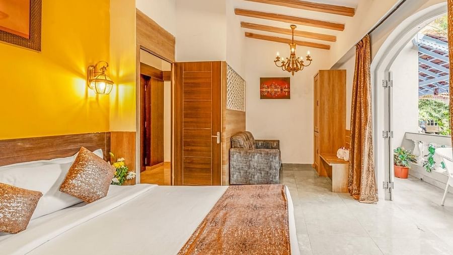 Image of Junior Suite with a bed and a balcony in front at Calux Joia Do Mar Resort, Goa