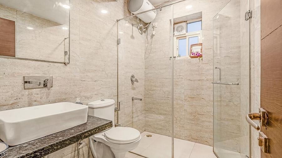Image of the washroom at Junior Suite with a sink and separate shower area at Calux Joia Do Mar Resort, Goa.