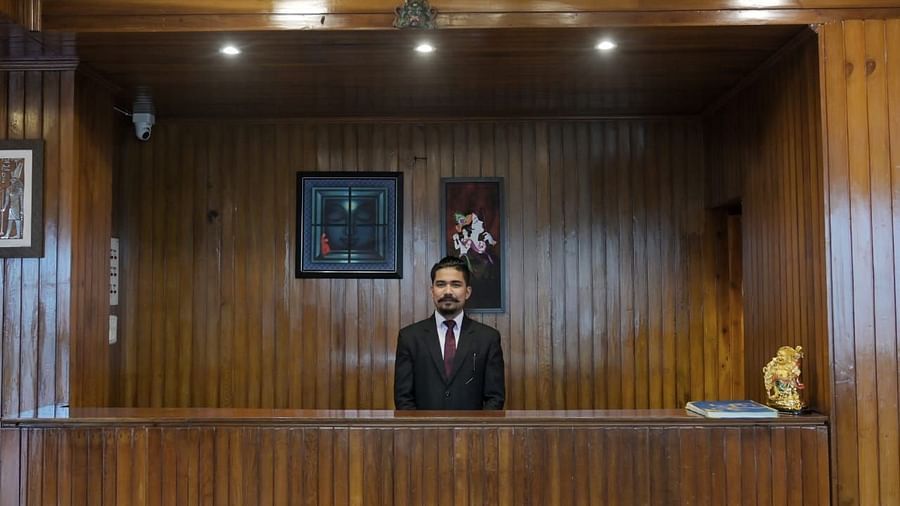 An image of man standing at the reception of Sumitel Chiminda, Pelling