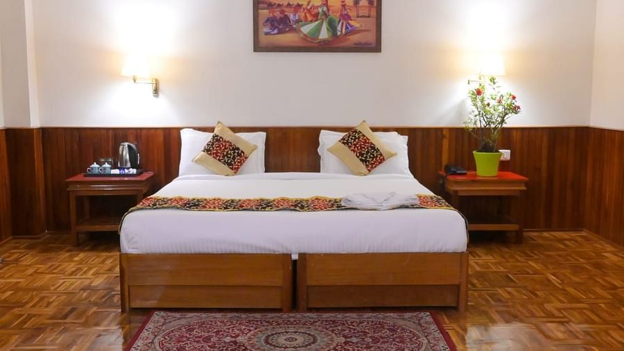 An image of a room featuring a bed, bed side table, wall hangings and rug - Sumitel Chiminda, Pelling