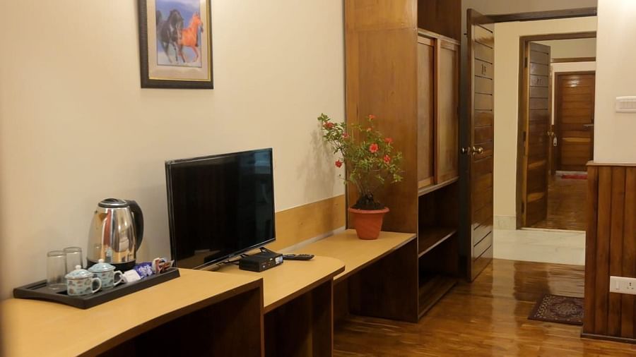 An image of a room featuring a flat screen TV, tea and coffee maker placed on a table - Sumitel Chiminda, Pelling