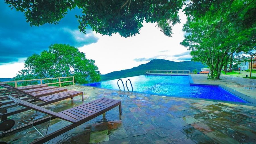 Chairs and a Swimming Pool at Grand Palace, Yercaud