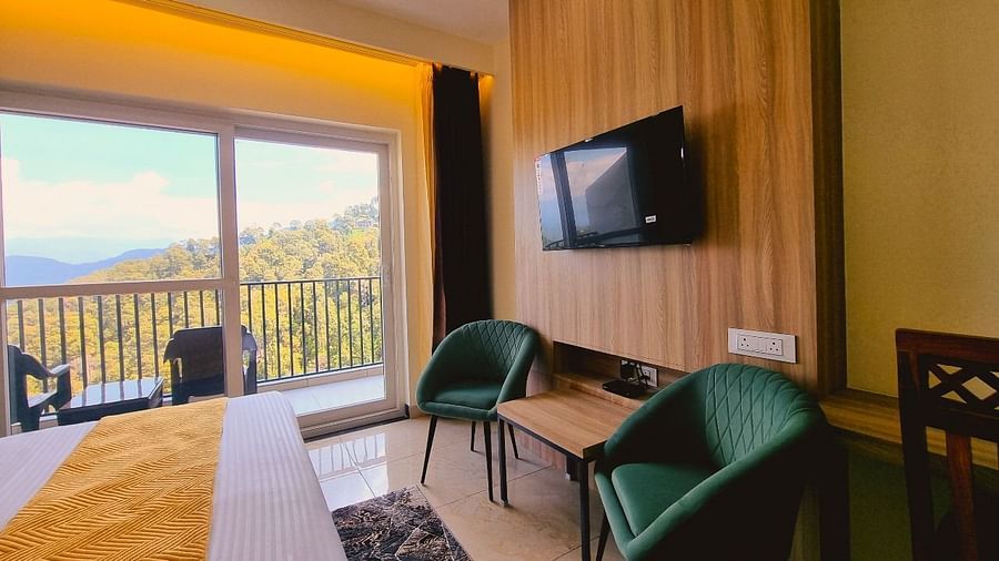Premium Room Valley View With with bed, chiars, television at Pines and Peaks, Dalhousie 