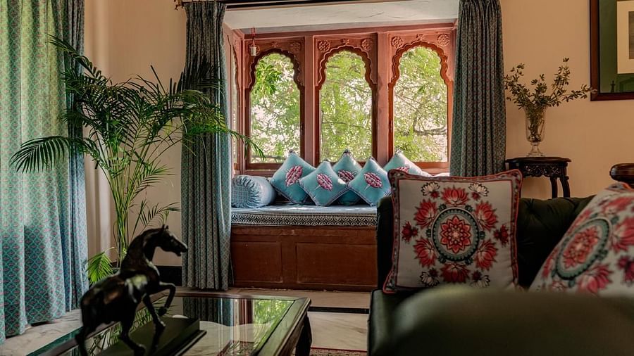 A well-lit living room with a window seating area and decorative cushions - Khas Bagh, Jaipur