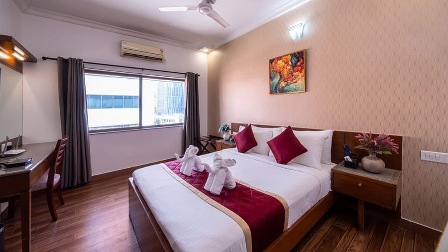 A cosy living room with comfortable sofas and wooden furniture offers a relaxing space at Lords Midtown Suites.