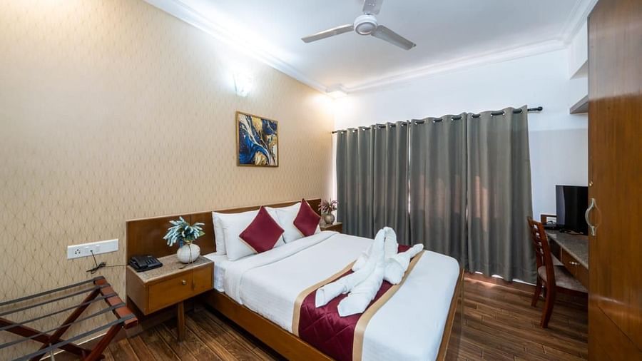 A well appointed bedroom with twin beds and elegant decor offers a comfortable stay at Lords Midtown Suites.