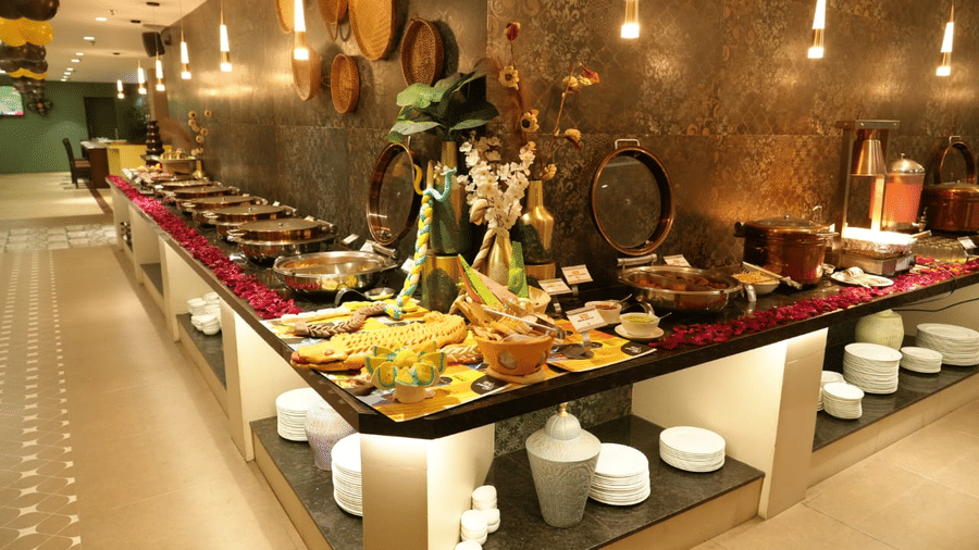 Lavish buffet setup at The Papaya Kitchen, Papaya Tree Hotels,  featuring a wide variety of dishes displayed in an elegant, modern dining space.