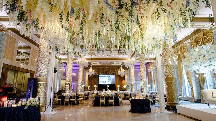 An overview of a banquet hall with round table seating and decor on the roof - Rhythm Gurugram.