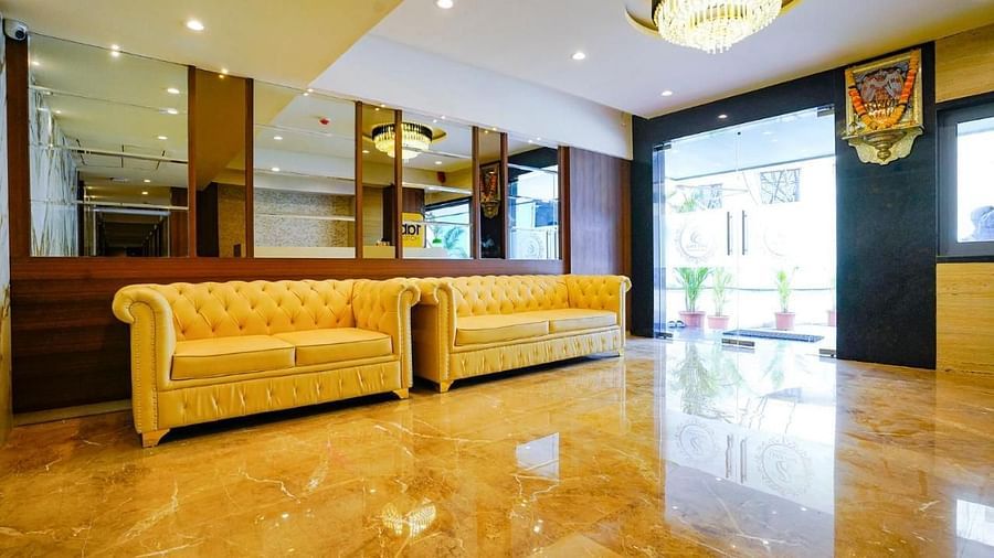 A view of the hotel lobby with yellow sofas and shiny floor - Shyanu Lords Eco Inn Airoli