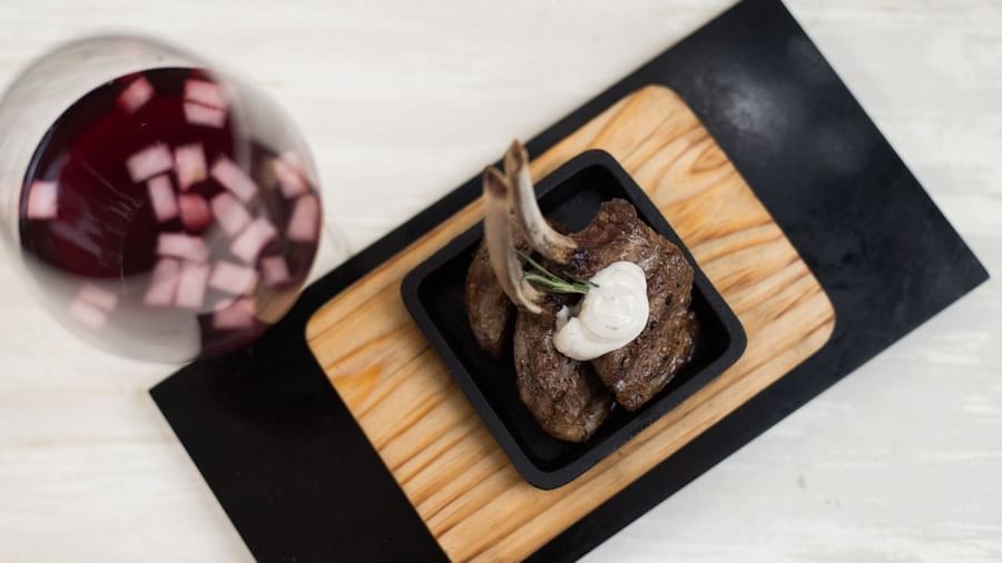 image of lips-making lamb cordero served with a glass of fine wine at the sevilla - The Claridges New Delhi