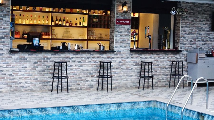 Bar by the pool with a wide selection of drinks. | Vistar Resort, Bengaluru