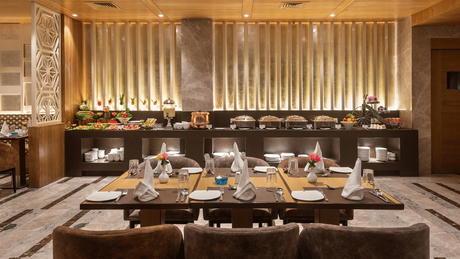 Warm, inviting restaurant interior with soft lighting, elegant table setups, and a premium curtains