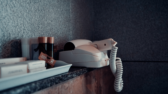 An iron and hairdryer are neatly arranged on a bathroom counter. - Abad Brookside Lakkidi, Wayanad