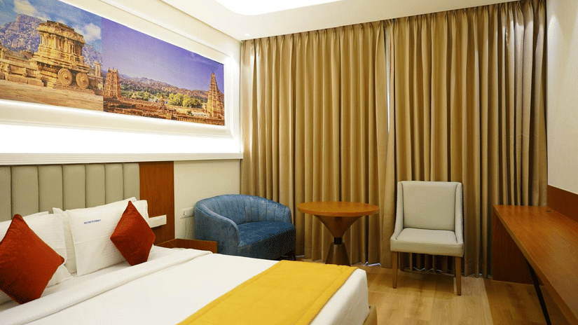 King room with natural light, seating, and bright decor at Kalyan Residency Hotel, Tirupati – comfort meets elegance.