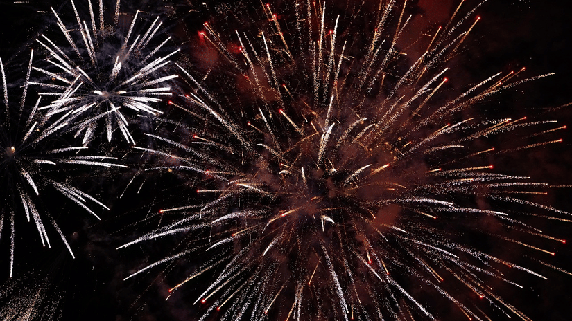 Fireworks bursting in the night sky during a celebration.
