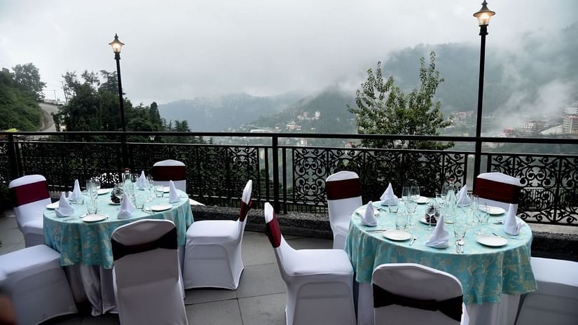 A seating arrangement with individual seats at the rooftop restaurant in Shimla - The Orchid Hotel Shimla