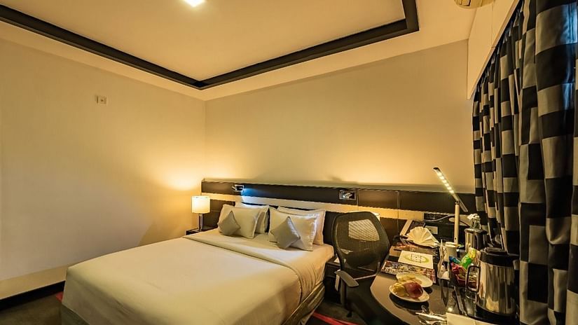 Deluxe AC room at The Pearl Hotel with a double bed
