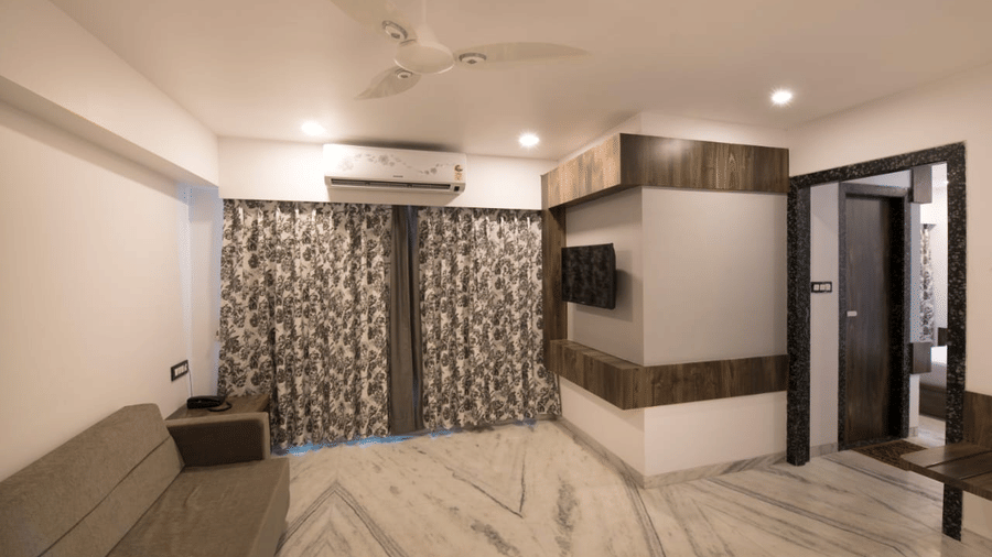 Living area of  Royal suite at sanmukh by adamo with its clean ambience and modern interiors.