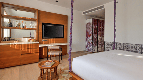 Luxury room with television, furniture and a private bar - Azaya Beach Resort Goa